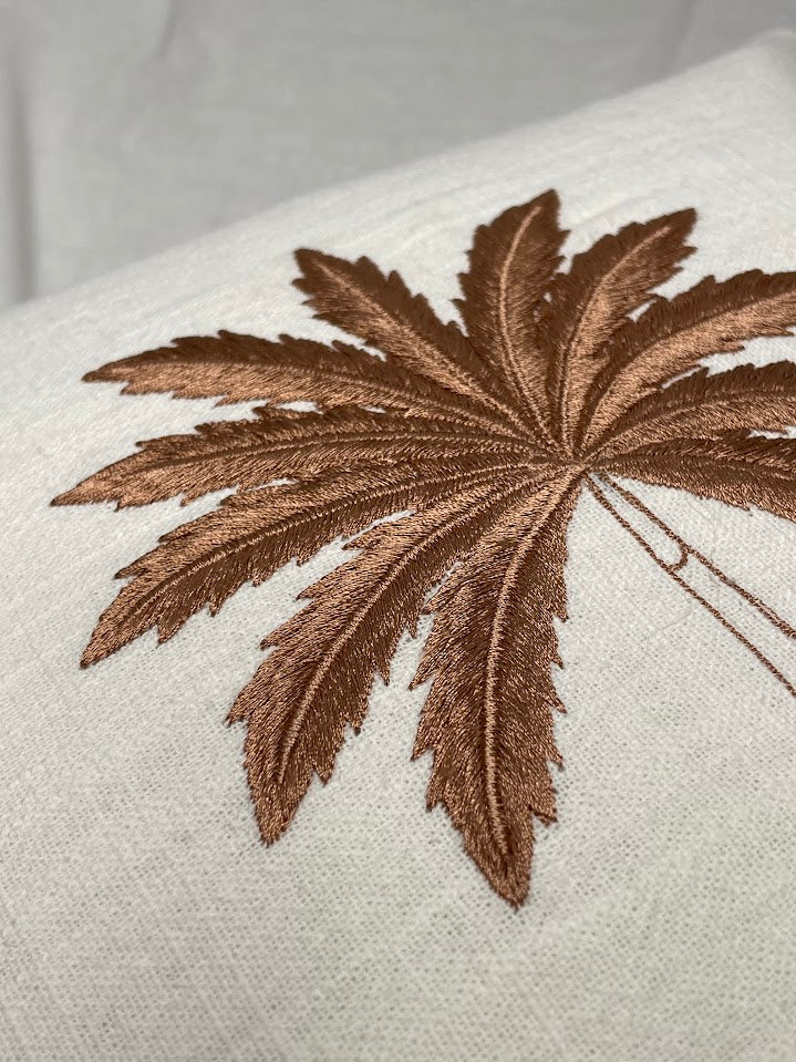 Close up details of palm tree leaves on a cushion cover