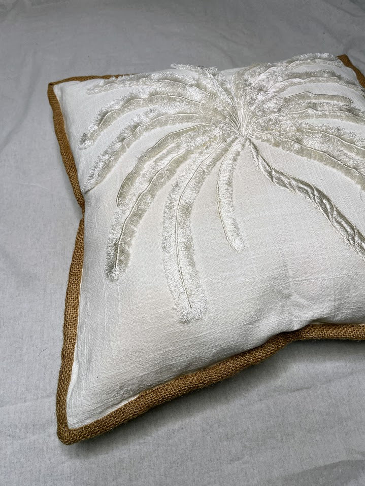 Close Up details of White Linen Cushion with large white hand sewn palm tree detailing and brown border