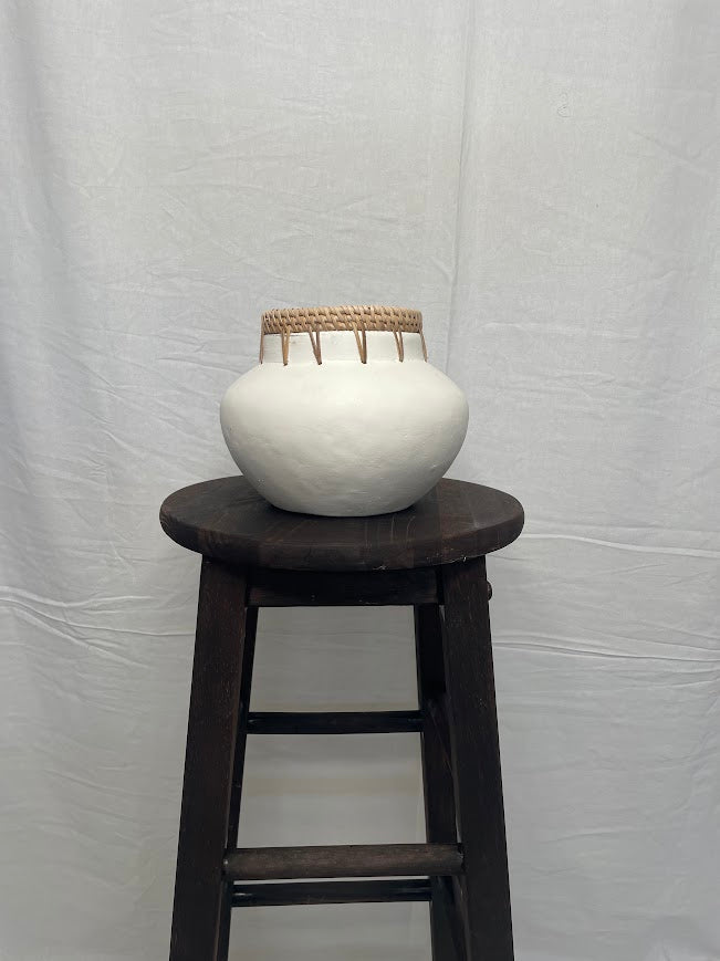 White vase pot with rattan detailing on the top outer rim