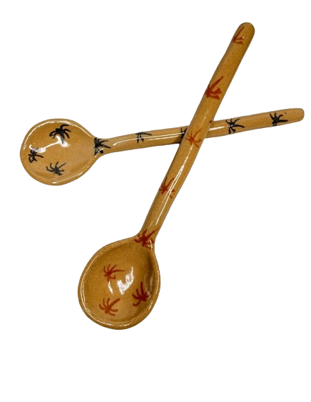 Two teaspoons, painted different colours with little palm trees