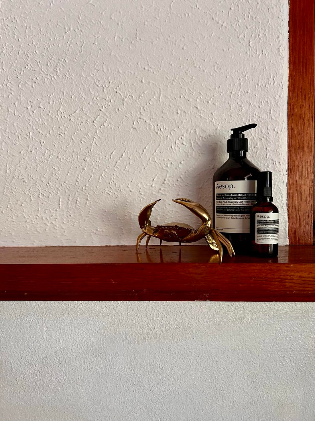 Brass crab sitting on fireplace mantle