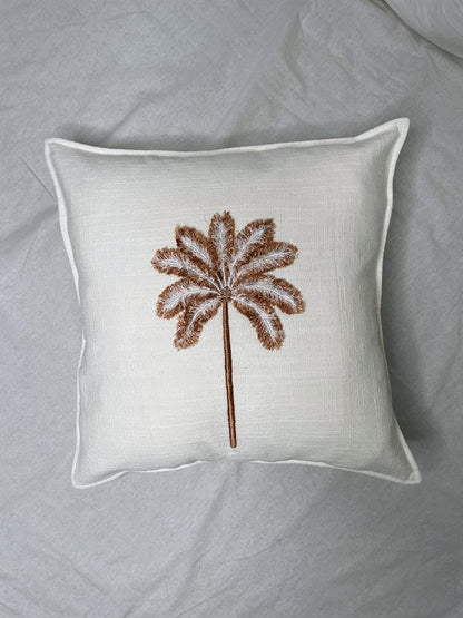 Unique linen cushion with brown palm tree hand sewn onto front with feather-like detailing