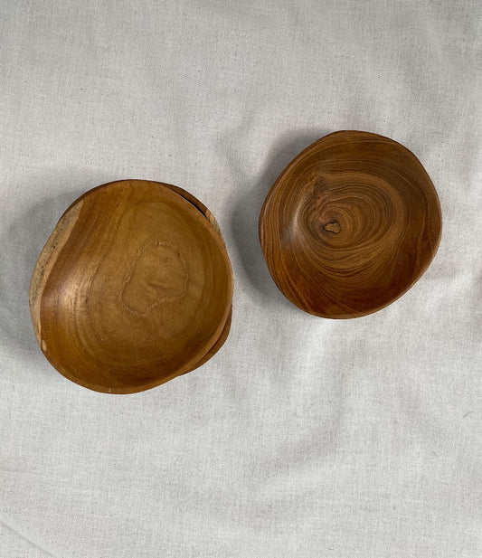 Two stacks of hand carved teak root wodden serving bowls