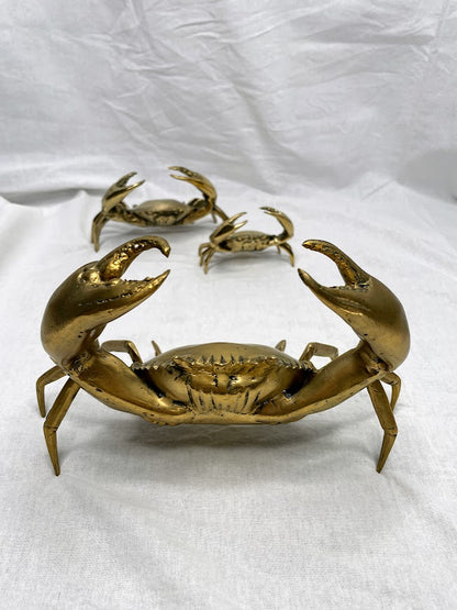 Three differently sized brass crab statues