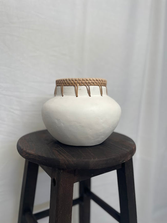 White vase pot with rattan detailing on the top outer rim