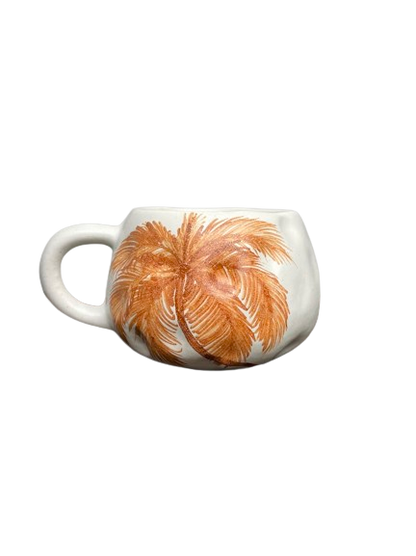 Short and round dimpled mug with single burnt orange palm tree painted on one side  