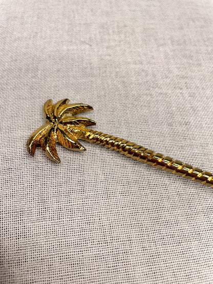 Close up details of palm tree brass teaspoon