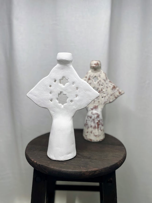 White candle decor object in focus with other colour options in background