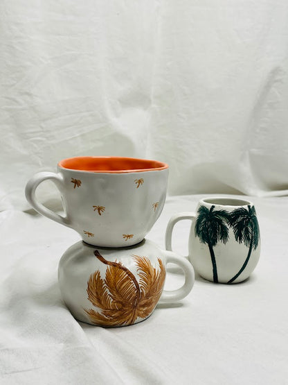 Collection of hand made and hand painted mugs with palm trees 